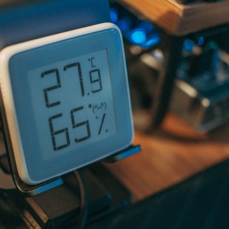 A digital display showing indoor temperature and humidity