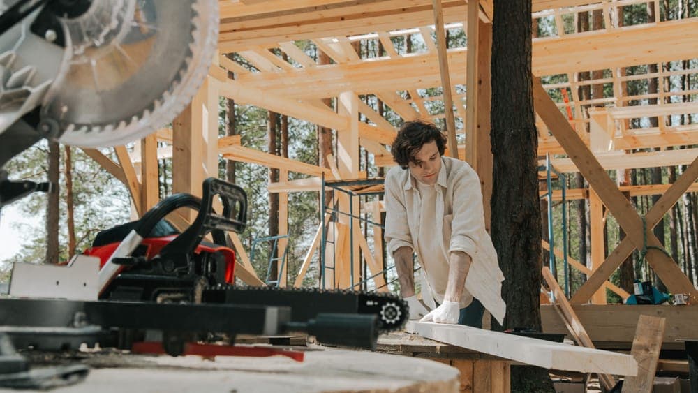 A timber greenhouse frame under construction
